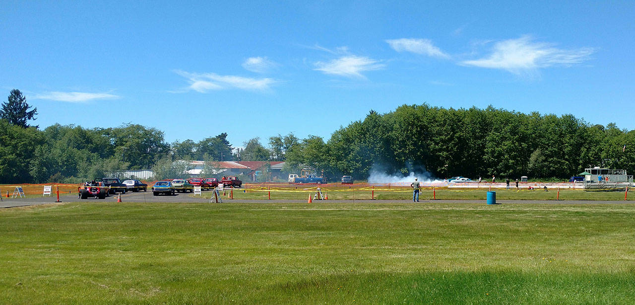 With temperatures Saturday in the mid-90s, two drivers were in mid-burnout down the 1/8-mile drag strip at the West End Thunder drag races at Forks Airport. (Zorina Barker/for Peninsula Daily News)