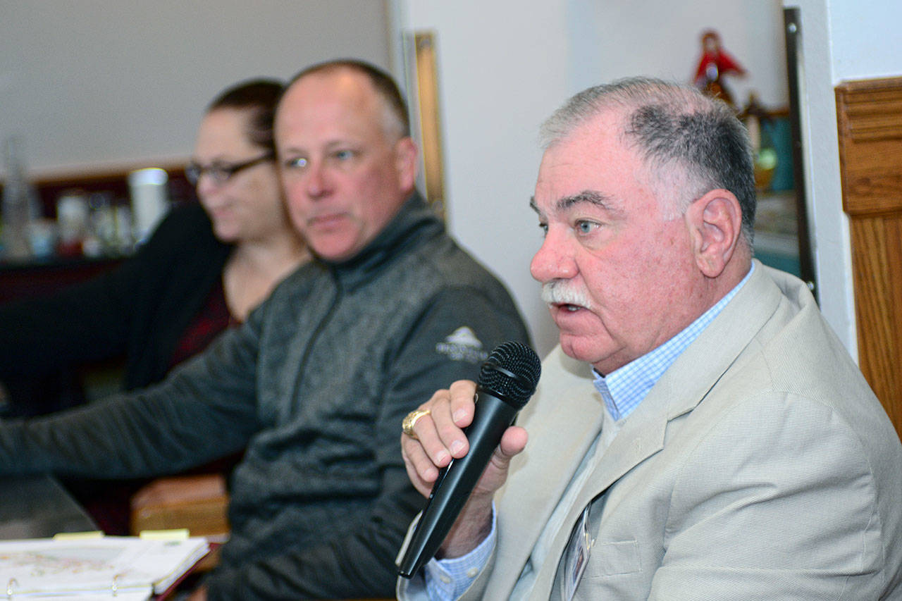 Jim Moran, right, candidate for Port Angeles City Council Position 1, answers a question during the Port Angeles Business Association candidate forum Tuesday. Marolee Smith, left, and Todd Negus also participated in the forum. (Jesse Major/Peninsula Daily News) 