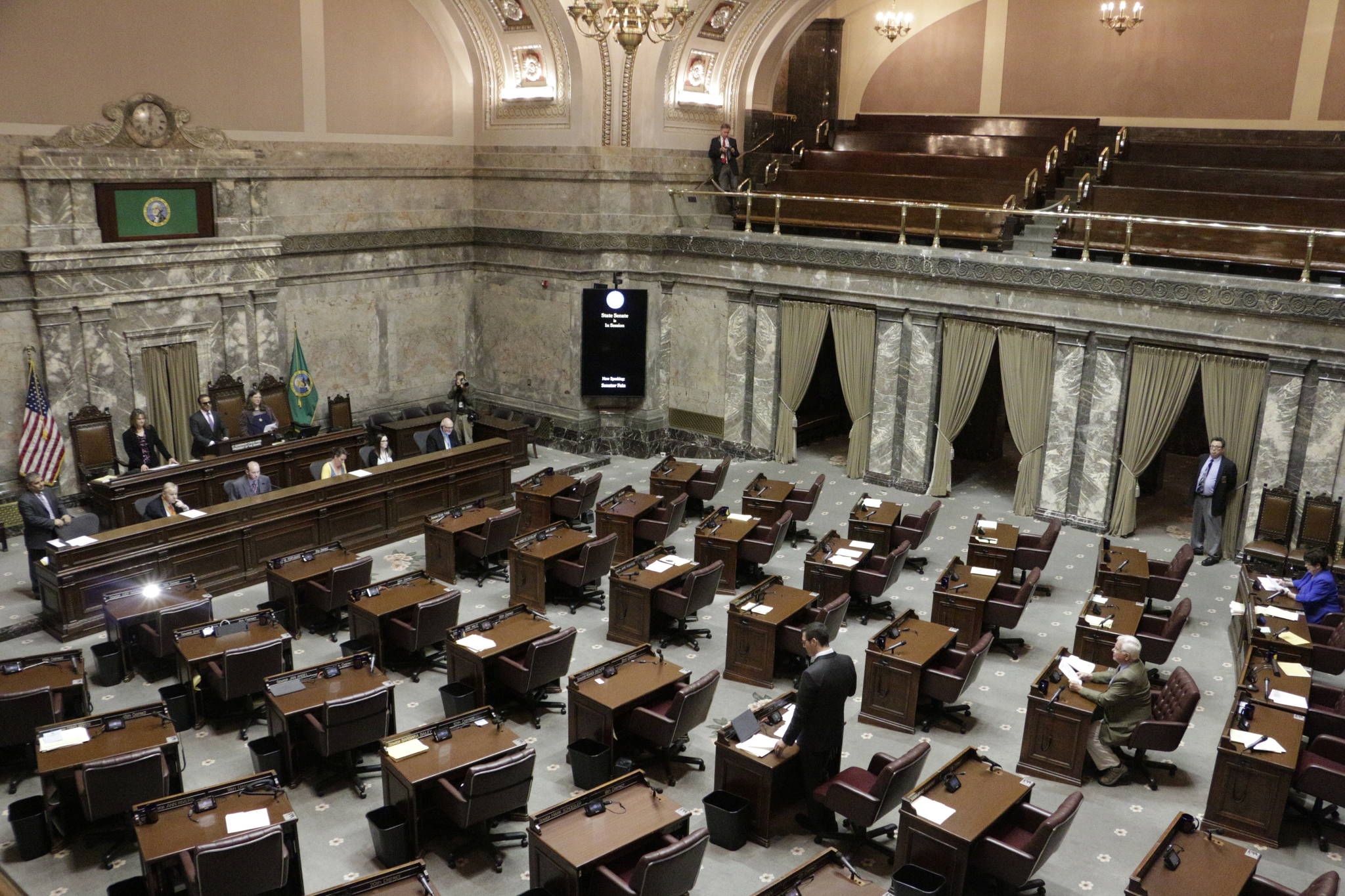 Republican Sen. Joe Fain, standing bottom center, speaks on the Senate floor during adjournment of a second special session Wednesday in Olympia. Lawmakers will need a third special session to complete their work on a new two-year state budget. (Rachel La Corte/The Associated Press)