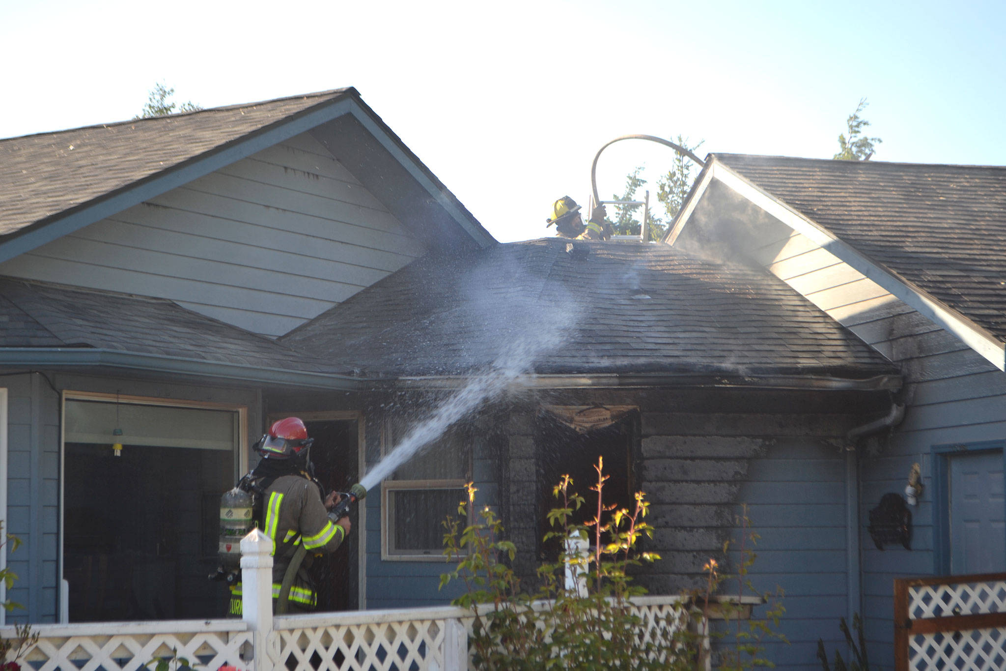 Matthew Nash (2)/Olympic Peninsula News Group A fire spread through the attic of a home on the 200 block of Griffith Farm Road on Sunday. Clallam County Fire District No. 3, with support from Clallam County Fire District No. 2 extinguished the fire in about two hours.