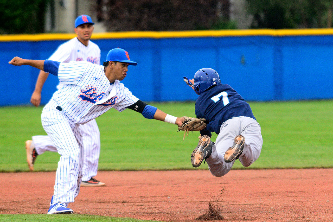 Jesse Major/Peninsula Daily News Port Angeles Lefties second baseman Mikey Hooper tags Victoria HarbourCats’ Kyle McComb on an attempted steal of second base during the Lefties first-ever game Thursday at Civic Field.