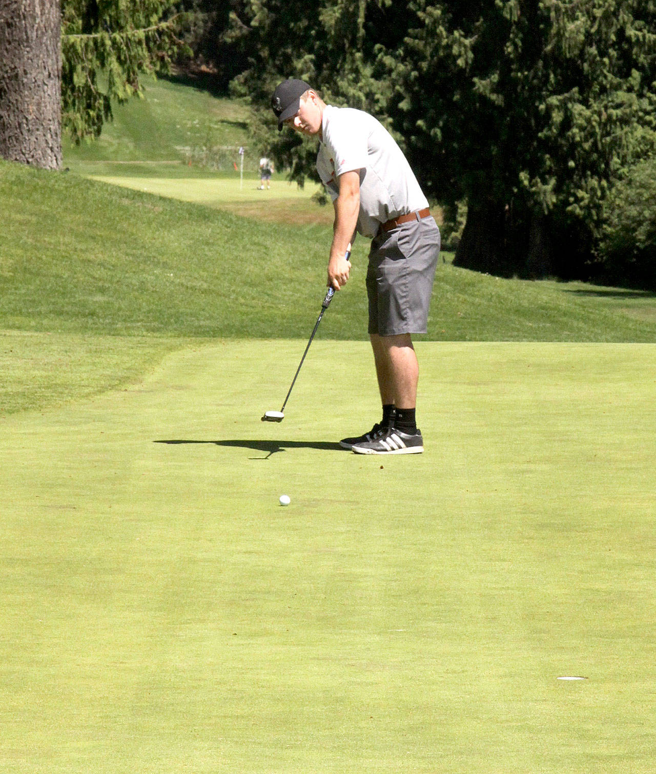 Dave Logan/for Peninsula Daily News Jack Shea, 19, putts on the 18th hole at Cedars at Dungeness Sunday to win the three-day Clallam County Amateur Golf Tournament with scores of 70-69-72 for a 211. Shea, a Sequim High School golfer who graduated in 2016, has won the event two years in a row.