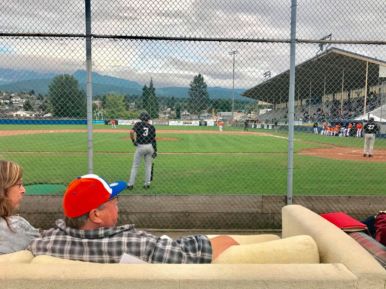 Port Angeles Lefties fans watch a game at Civic Field from the comfort of couches lined up behind the backstop Friday. (Paul Gottlieb/Peninsula Daily News)
