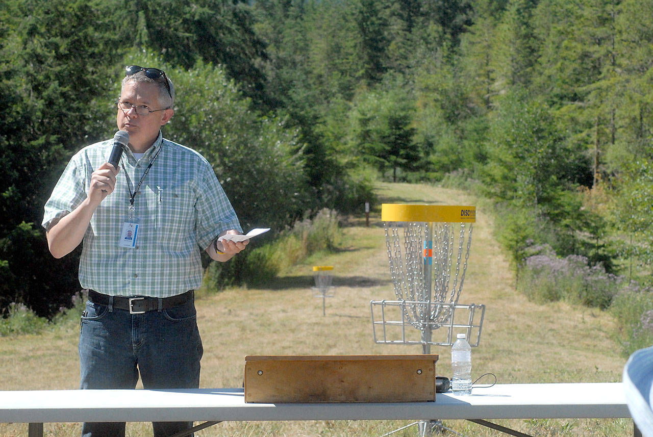 Clallam County Parks, Fair & Facilities director Joel Winborn speaks at the first tee during Wednesday’s official opening of the Rainshadow Disc Golf Park near Blyn. (Keith Thorpe/Peninsula Daily News)