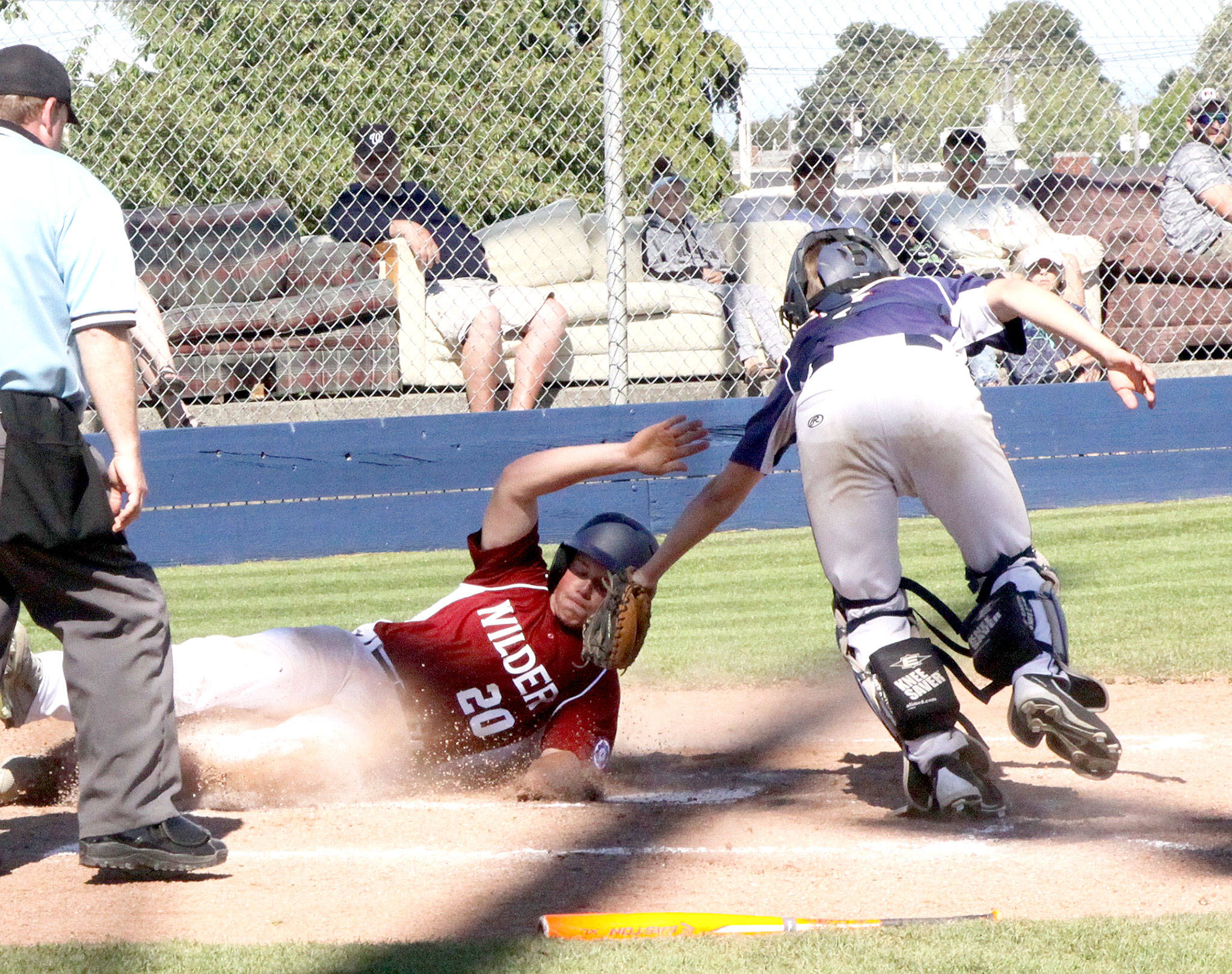 Dave Logan/for Peninsula Daily News Dave Logan/for Peninsula Daily News Reese Blatner of Wilder Senior slides successfully into home as Wilder Junior catcher Devin Batchelor tags him on Sunday afternoon. Wilder Senior won 13-2.