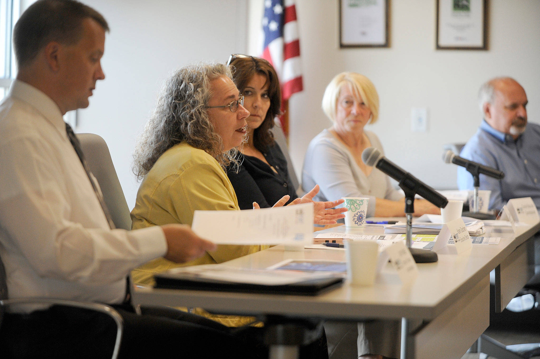 Port of Port Angeles executive director Karen Goschen talks with Clallam County PUD officials Aug. 1. Pictured from left are John Nutter, port director of finance and administration; Goschen; and Port Commissioners Colleen McAleer, Connie Beauvais and Steve Burke. (Michael Dashiell/Olympic Peninsula News Group)