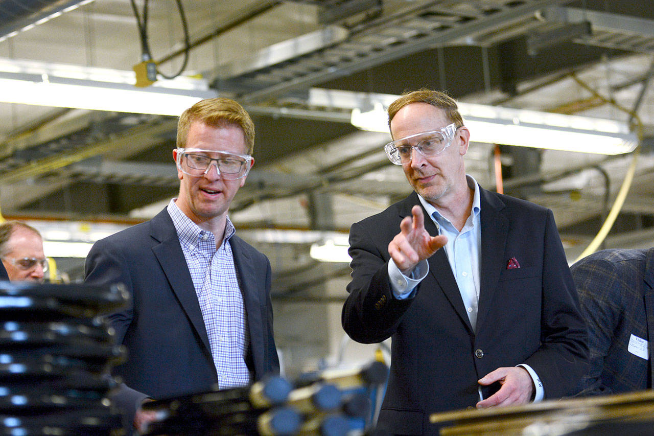 U.S. Rep. Derek Kilmer, D-Gig Harbor, left, talks with Composite Recycling Technology Center Chief Operating Officer Dave Walter during a tour of the facility Tuesday. (Jesse Major/Peninsula Daily News)