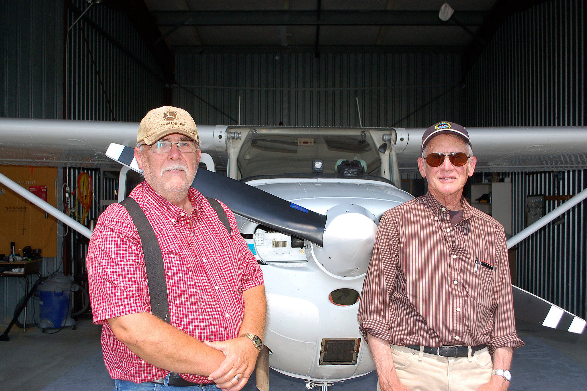 Erin Hawkins/Olympic Peninsula News Group                                Sequim residents and airplane owners Dan Ramberg, left, and John Meyers stand in Ramberg’s airplane hangar at Sequim Valley Airport.