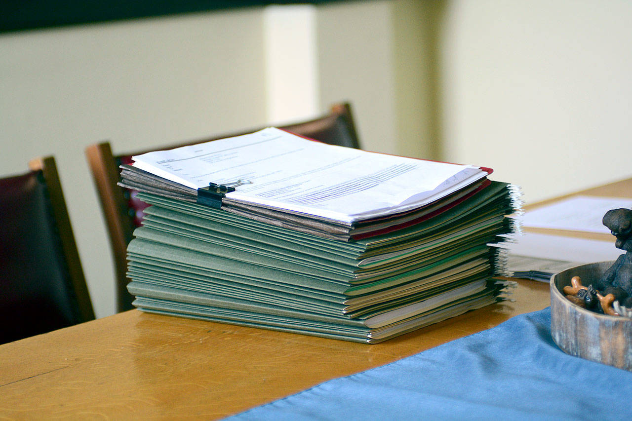 Records compiled for William Sheehan of Edmonds sit on a table in the Clallam County Courthouse. Clallam County Sheriff Bill Benedict said it would likely take hundreds of hours to fulfill Sheehan’s records requests. (Jesse Major/Peninsula Daily News)