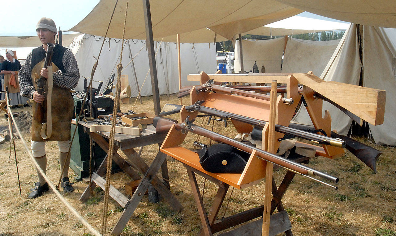 Gunsmith Dave Rieve of Kent holds a blunderbuss as he describes the process of making firearms at the time of the American Revolution. (Keith Thorpe/Peninsula Daily News)