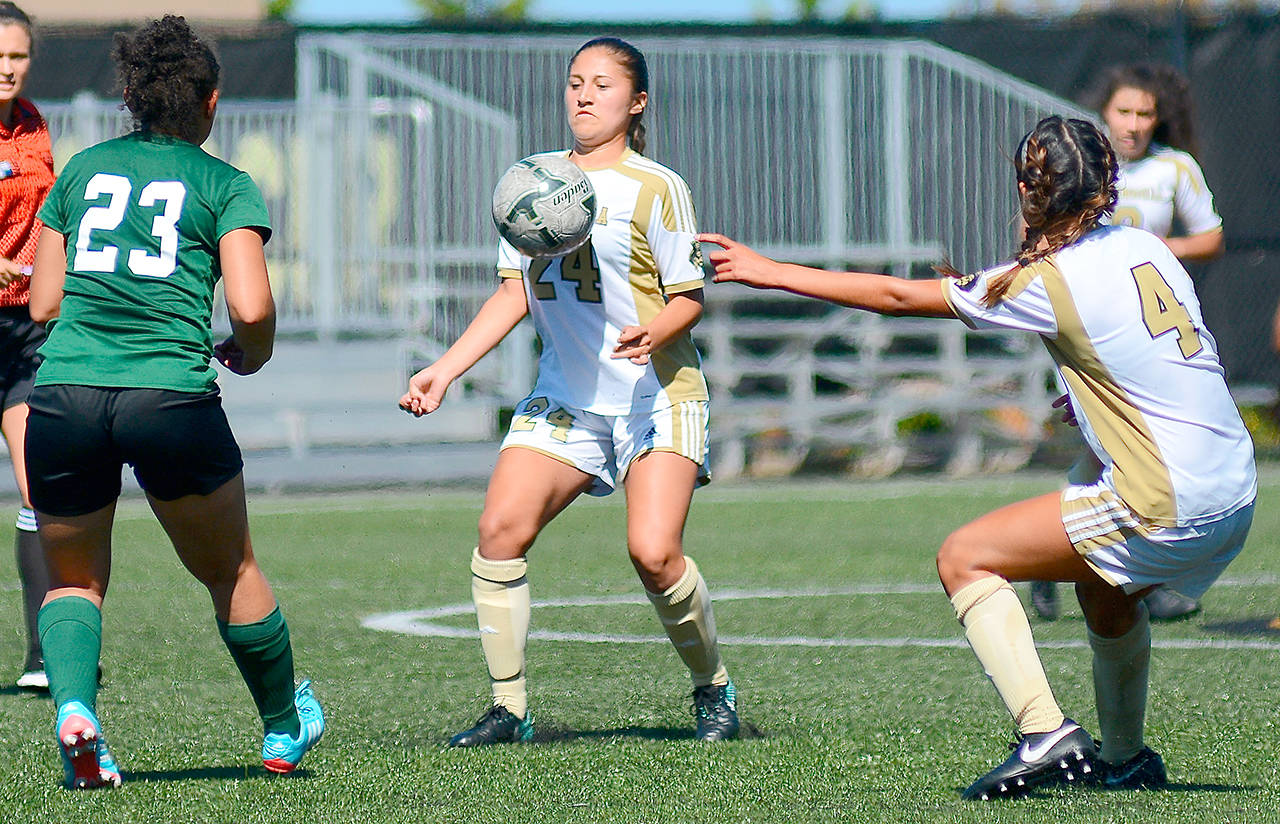 Jay Cline/for Peninsula Daily News                                Peninsula’s Janis Martinez, center, settles the ball while teammate Shantel Torres-Benito points upfield during the Pirates 5-1 exhibition win over The Evergreen State College at Wally Sigmar Field on Tuesday.
