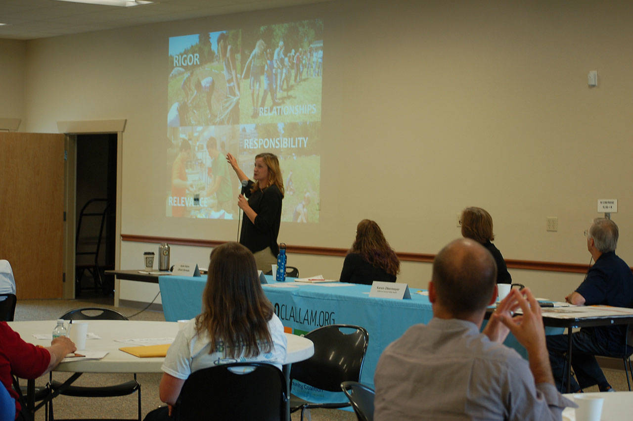 Left, Katie Rains, executive director of GRuB Olympia, gave a presentation about the organization’s services that aim to inspire community change by bringing people together around food and agriculture. (Erin Hawkins/Olympic Peninsula News Group)