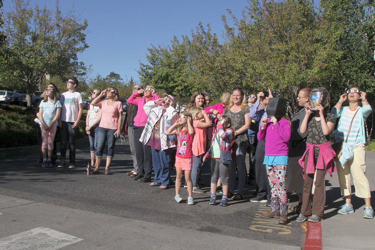 A large crowd of around 100 gathered at the Port Angeles public library to watch the eclipse. (Dave Logan/for Peninsula Daily News)