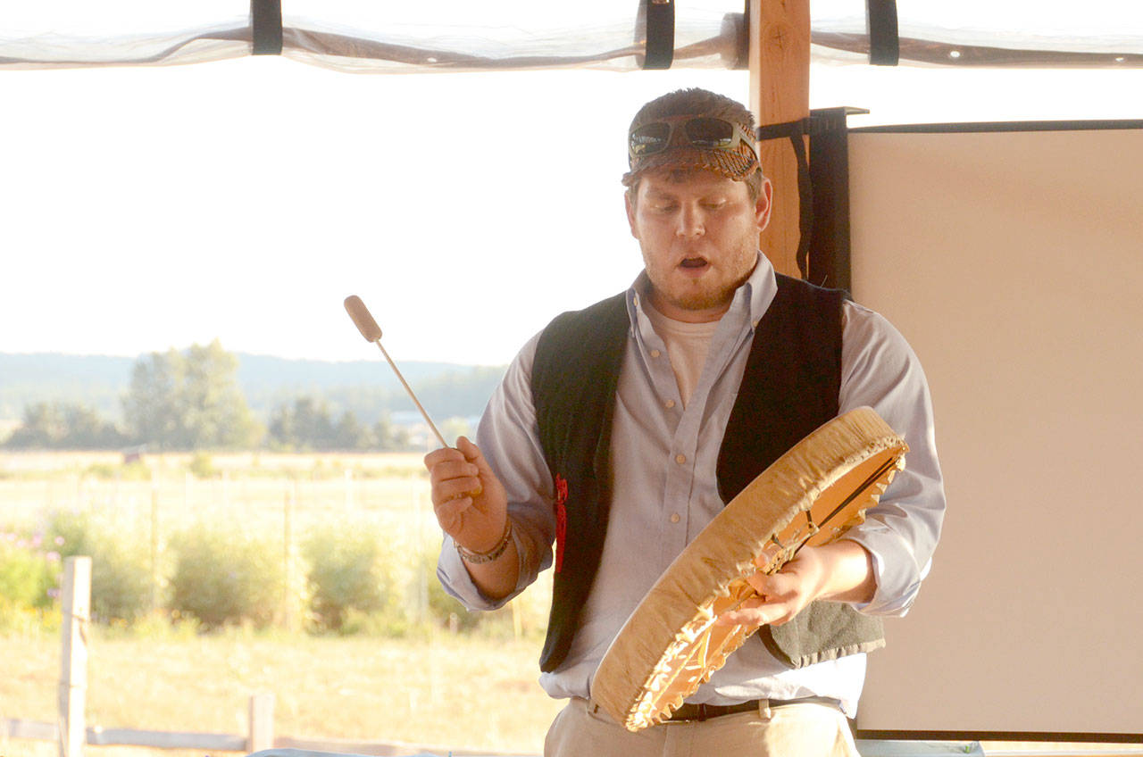Hawk Grinnell of the Jamestown S’Klallam Tribe shares a traditional song at Finnriver Cidery in Chimacum on Tuesday night during a fundraiser for the RAVEN trust, a nonprofit helping tribes in Canada fight the Kinder Morgan Pipeline. (Cydney McFarland/Peninsula Daily News)