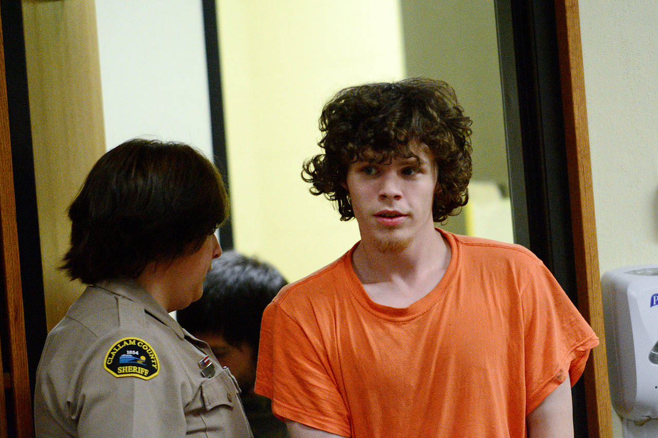 Joseph Warren Recoy, 24, is escorted into Clallam County Superior Court last month. (Jesse Major/Peninsula Daily News)
