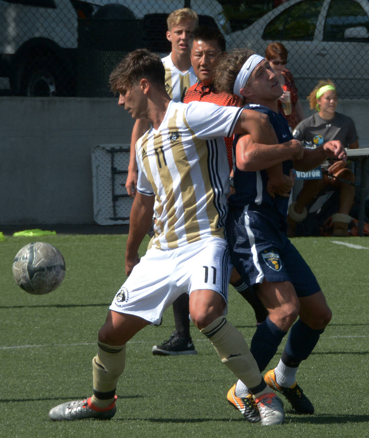 Rick Ross/Peninsula College Athletics Peninsula’s Manuel Galiano (11) holds back a Spokane player during the Pirates’ 3-1 loss to the Sasquatch at the NWAC Friendlies in Tukwila on Friday.