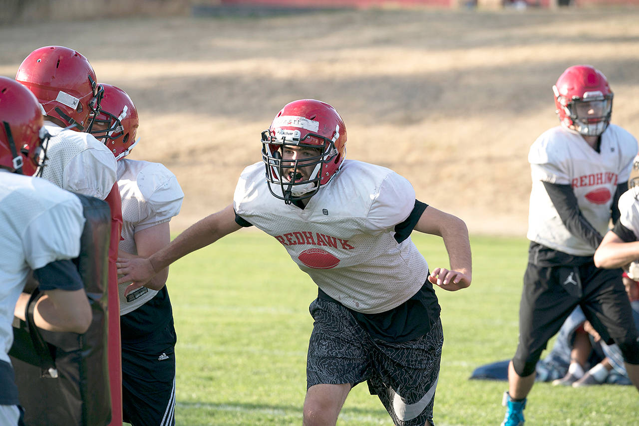 Steve Mullensky/for Peninsula Daily News Port Townsend’s Robert Hammett works through a blocking drill during a preseason practice. The Redhawks visit Port Angeles tonight at 7 p.m. at Civic Field.