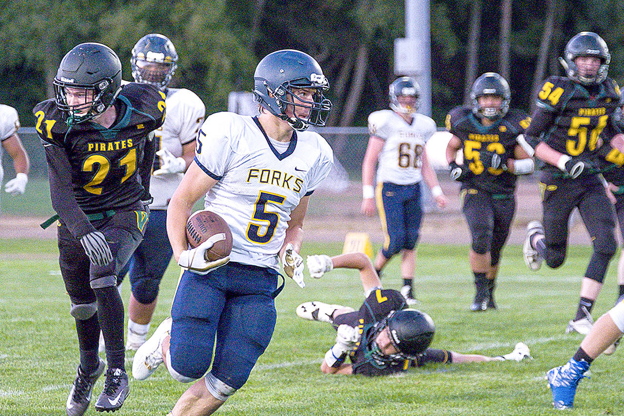 Kent Phelan/Vashon Beachcomber Forks’ Cole Baysinger leaves defenders in his wake during a Spartans’ win earlier this season against Vashon.