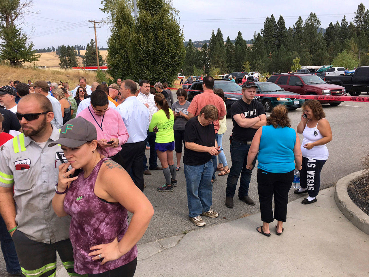 Parents gather in the parking lot behind Freeman High School in Rockford to wait for their kids after a deadly shooting at the high school Wednesday. (Dan Pelle/The Spokesman-Review via AP)