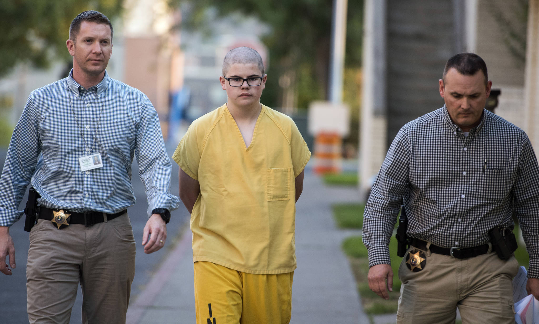 Spokane County sheriff’s deputies escort Caleb Sharpe from the Public Safety Building to the Juvenile Detention Center in Spokane on Wednesday. (Colin Mulvany/The Spokesman-Review via AP)