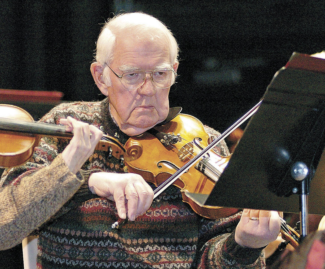 Paul Cornaby plays his violin during a rehearsal of Glazounow’s “Valse De Concert” at Port Angeles High School in December 2009. (Peninsula Daily News)