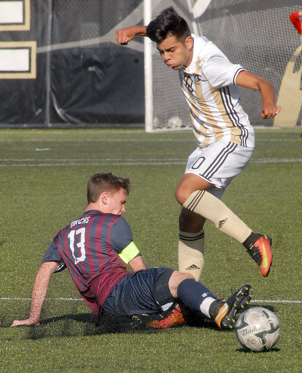 Peninsula’s Cesar Gervacio. right, tries to avoid the tackle from Whatcom’s Eric Jones in first-half play on Wednesday in Port Angeles. Keith Thorpe/Peninsula Daily News