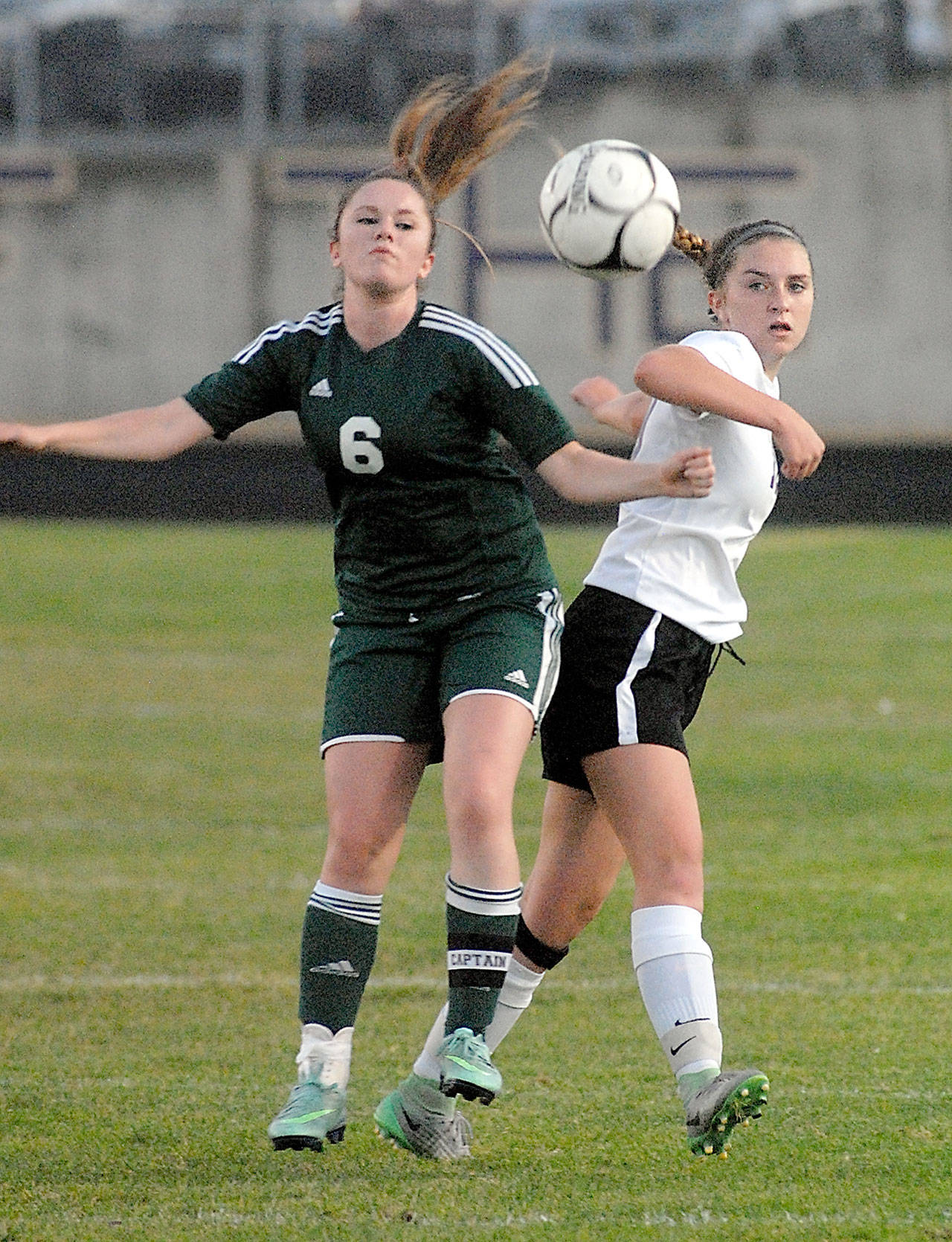 Port Angeles’ Emily Boyd, left, and Sequim’s Gabbe Happe battle for the ball in the first half on Tuesday at Sequim High School.                                Keith Thorpe/Peninsula Daily News