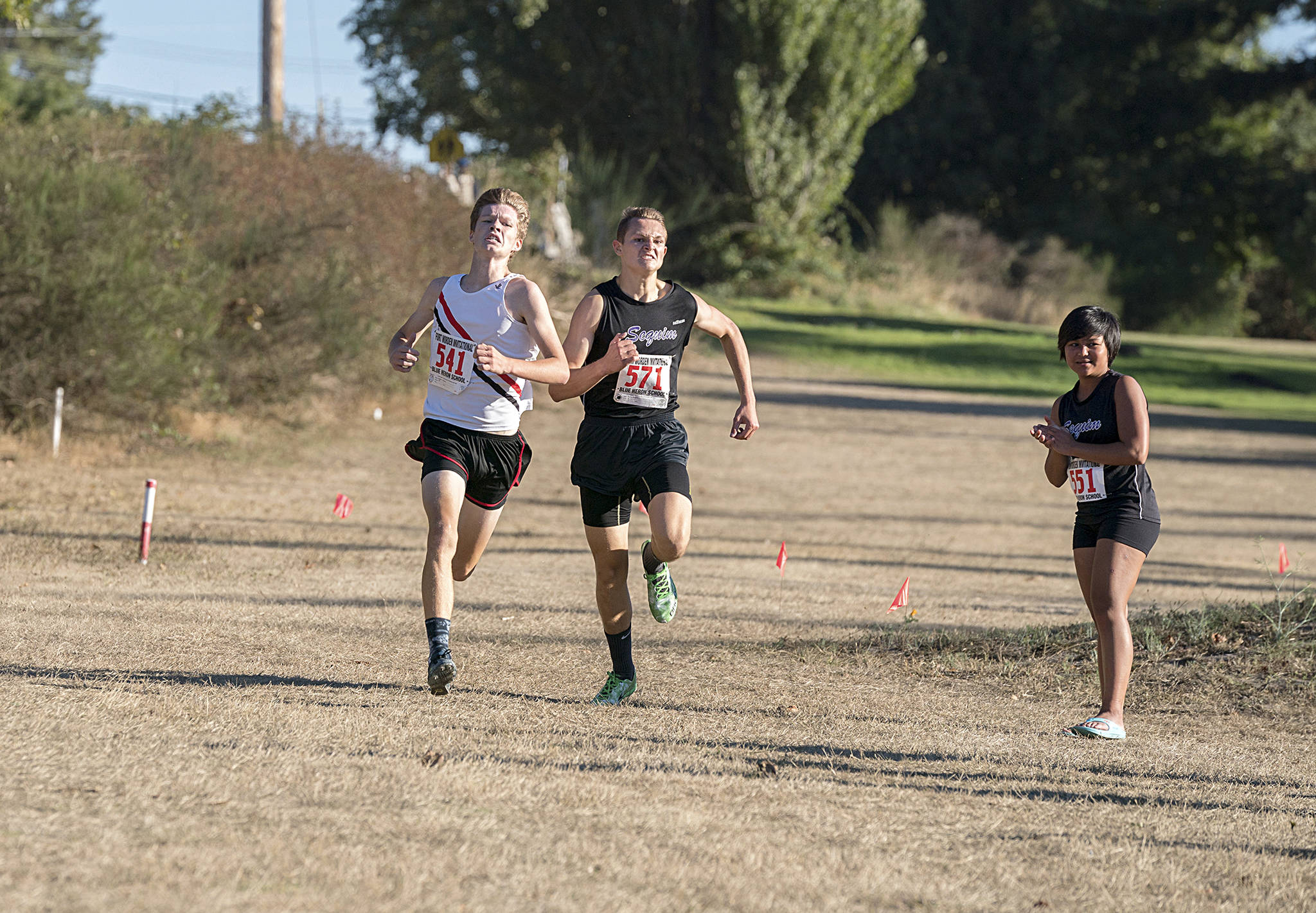Steve Mullensky/for Peninsula Daily News Port Townsend’s Nathan Cantrell, left, and Sequim’s Murray Bingham sprint to the finish during a cross country meet at Port Townsend Golf Club. Cantrell took the lead in the last 20 meters to pick up the win.