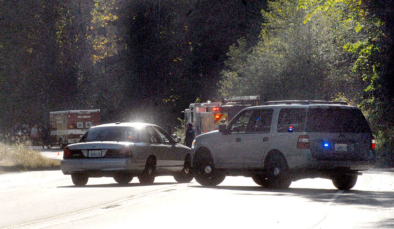 Police and rescue workers converge on the Tumwater Truck Route beneath the western Eighth Street bridge after witnesses said a man leaped from the span Wednesday afternoon. (Keith Thorpe/Peninsula Daily News)