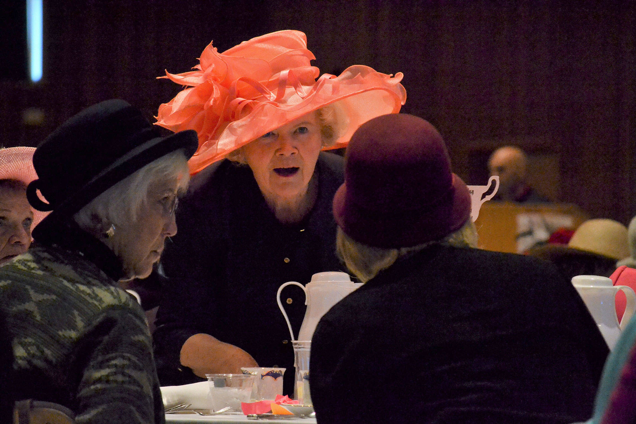 Matthew Nash/Olympic Peninsula News Group Shirley Sutterlin serves water to Evelyn and Sandy Bequette at the Mad Hatter’s Tea.
