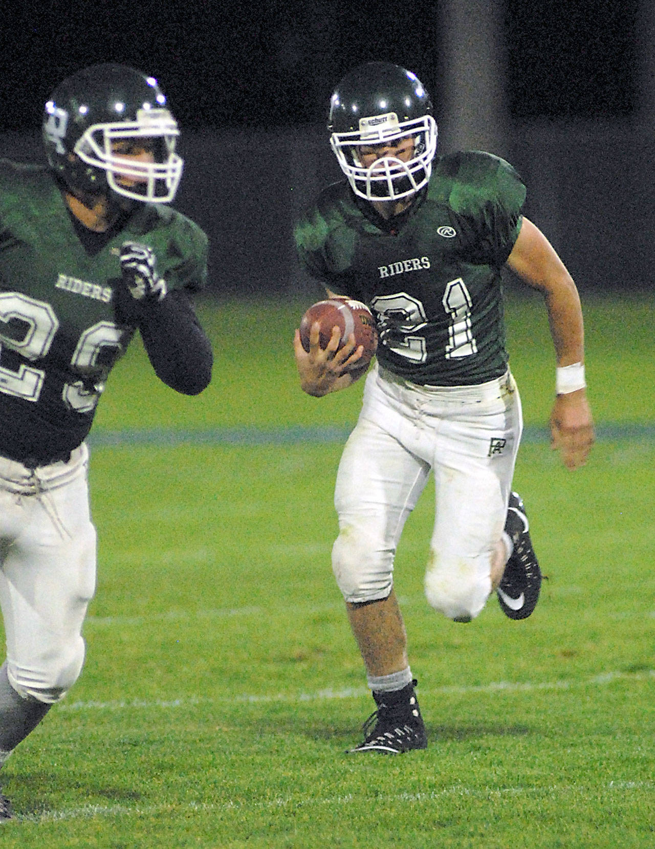 Port Angeles’ Jarrett Burns, center, rushes with the assistance of teammate Jake Allen, left, during his team’s Sept. 29 game against Kingston at Port Angeles Civic Field. Keith Thorpe/Peninsula Daily News