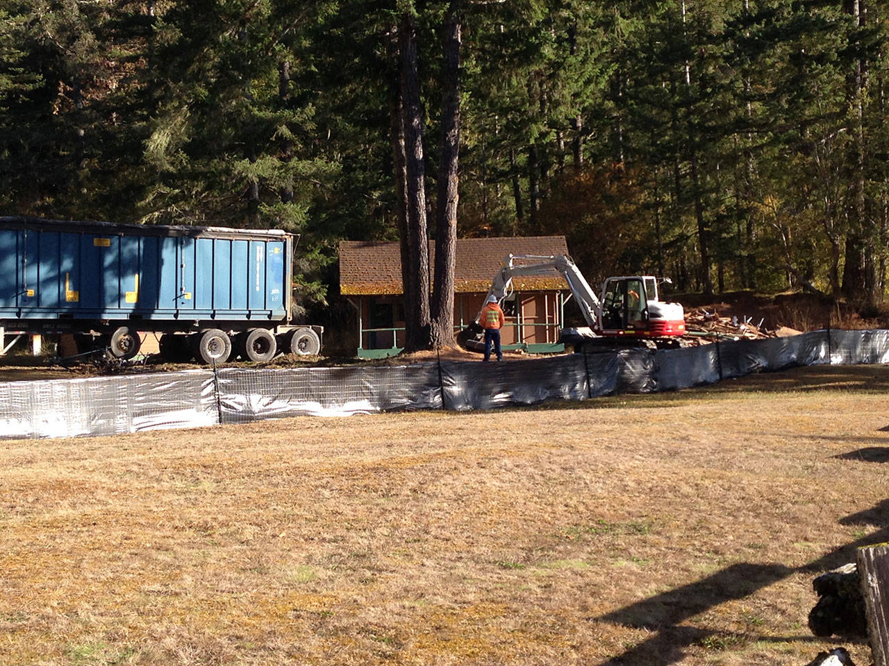 Deteriorated log cabins are demolished at the Log Cabin Resort at Lake Crescent. They will be replaced in a $2.2 million project. (National Park Service)