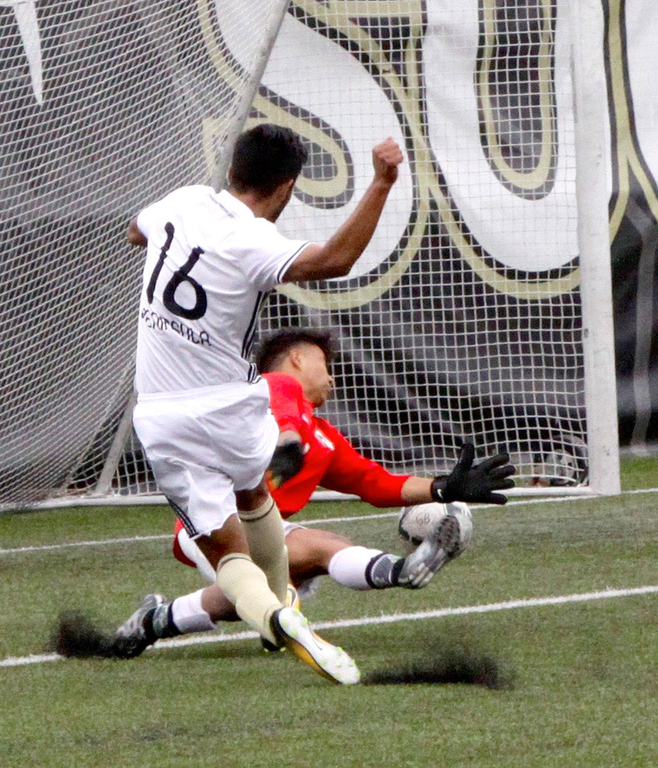 Peninsula’s Juan Carrillo-Perez kicks the ball past Shoreline goalie Genero Ruiz for the Pirates’ first goal of the game in a 4-1 win Saturday. (Dave Logan/for Peninsula Daily News)
