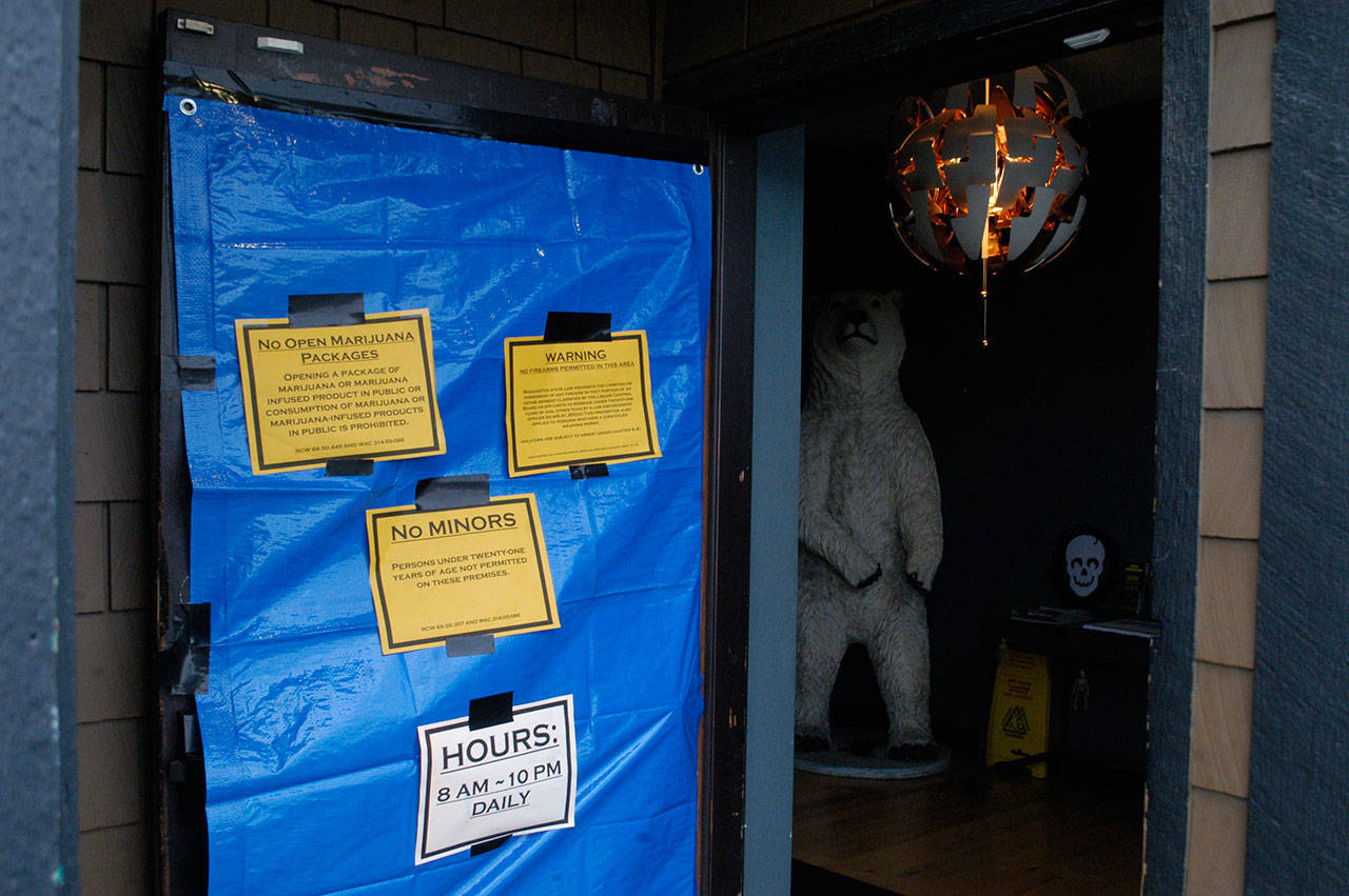 The damaged door of Mister Buds retail marijuana shop in Port Angeles is seen Monday. (Rob Ollikainen/Peninsula Daily News)