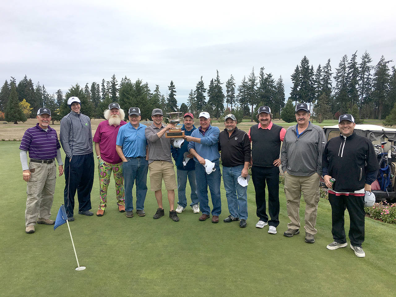A team from Peninsula Golf Club topped teams from Port Townsend Golf Club, The Cedars at Dungeness and SkyRidge Golf Course to repeat as Peninsula Cup champions on their home course. Team members are: Mark Mitrovich, Gary Thorne, Jade Tisdale, Bob Dutrow, Gerald Petersen, Jered Pomeroy, Steve Main, John Pruss, Jan Hardin, Derek Schumacher and Allen Osterberg. Not pictured: Bernie Anselmo.