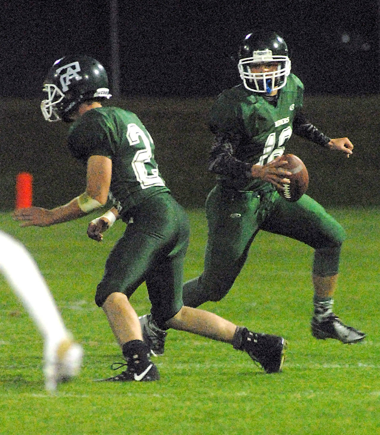 Keith Thorpe/Peninsula Daily News Port Angeles’ Easton Joslin, right, sweeps around teammate Jarret Burns during last week’s game against Bremerton at Port Angeles Civic Field.