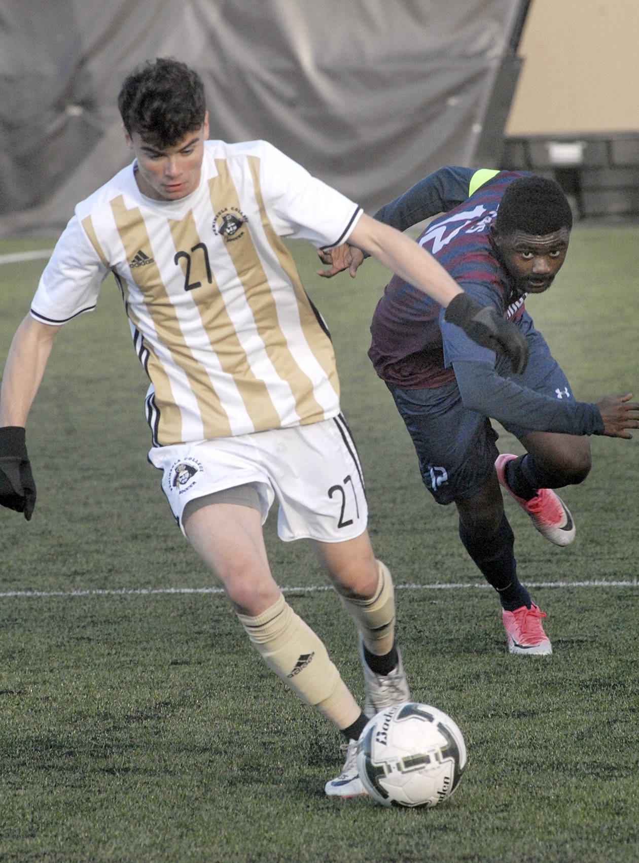Keith Thorpe/Peninsula Daily News                                Peninsula’s Michael Day dribbles past Whatcom’s Jerry Merveille on Wednesday in Port Angeles.
