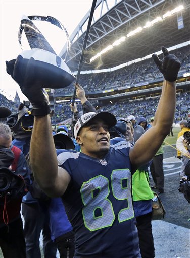 Seattle Seahawks' Doug Baldwin holds up George Halas Trophy after overtime of the NFL football NFC Championship game against the Green Bay Packers. (The Associated Press)