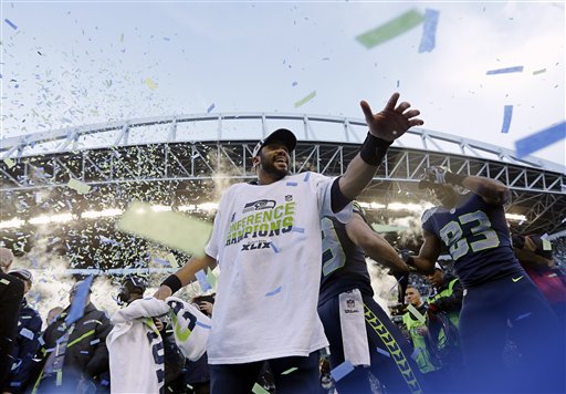 Seattle Seahawks' Russell Wilson celebrates after overtime of the NFL football NFC Championship game against the Green Bay Packers. (The Associated Press)