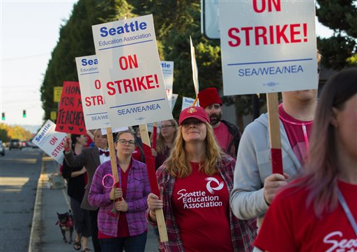 Striking teachers picket in front of schools in West Seattle on Thursday. The Associated Press (Click on image to enlarge)