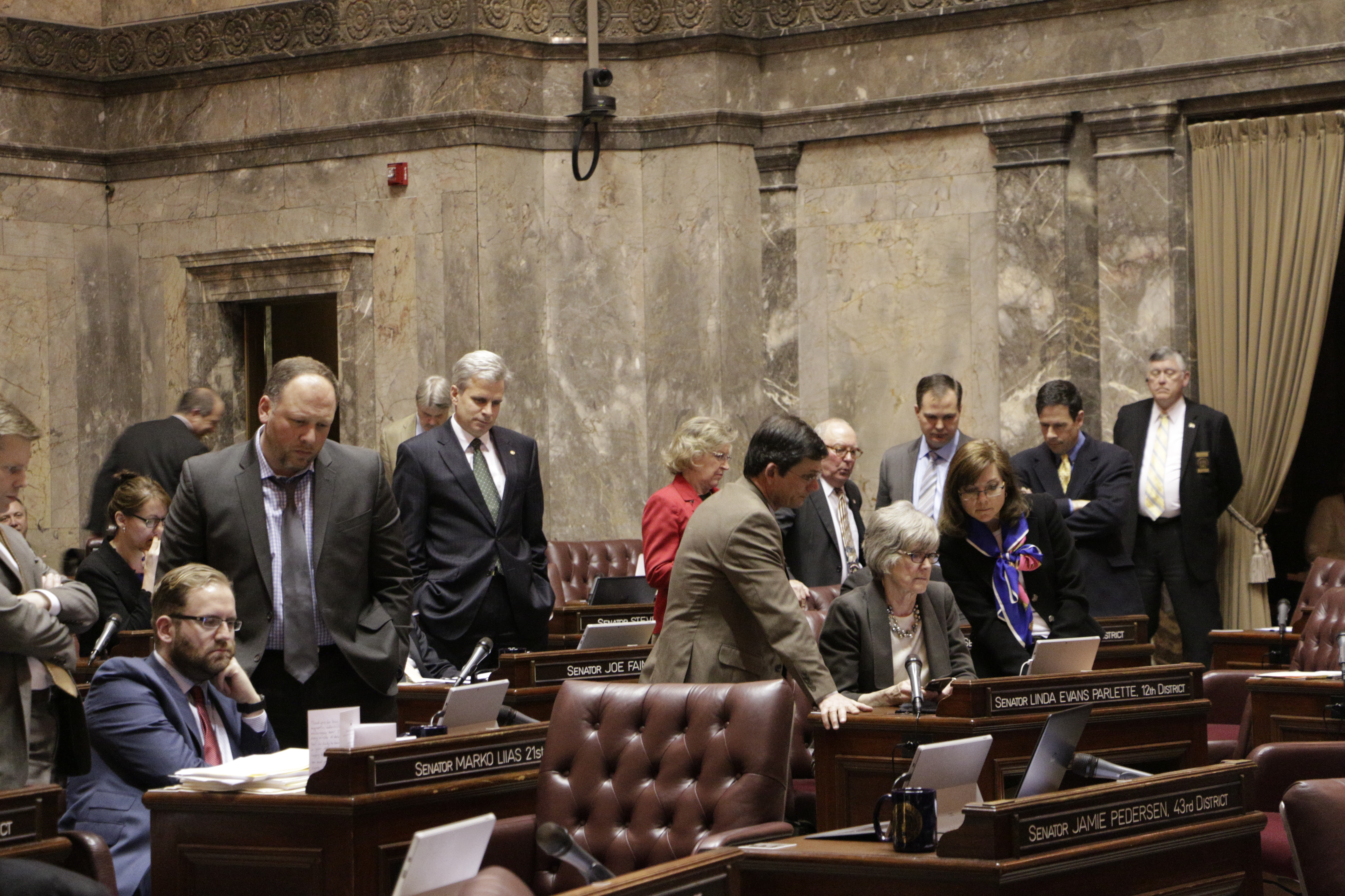 Senators watch a vote count on their computers during a vote on the Senate floor on a supplemental budget on Tuesday in Olympia. The budget passed on a 27-17 vote. (The Associated Press)