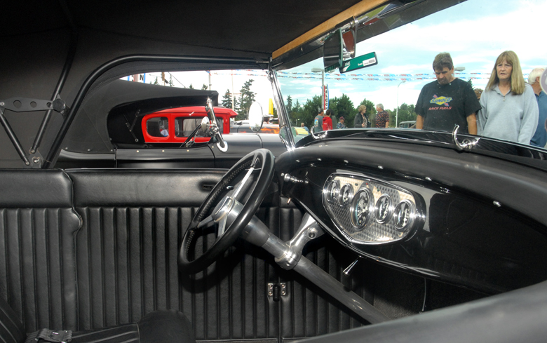 Bob and Carrie Matney of Olympia examine a 1932 Ford Roadster on display at Friday night's Ruddell Cruise-In car show at the Ruddell Auto Mall in Port Angeles. (Keith Thorpe/Peninsula Daily News)