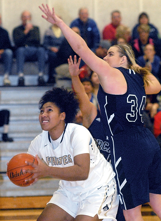Peninsula's Tai Thomas ducks underneath the defense of Whatcom's Lindsey Honeycutt. (Keith Thorpe/Peninsula Daily News)