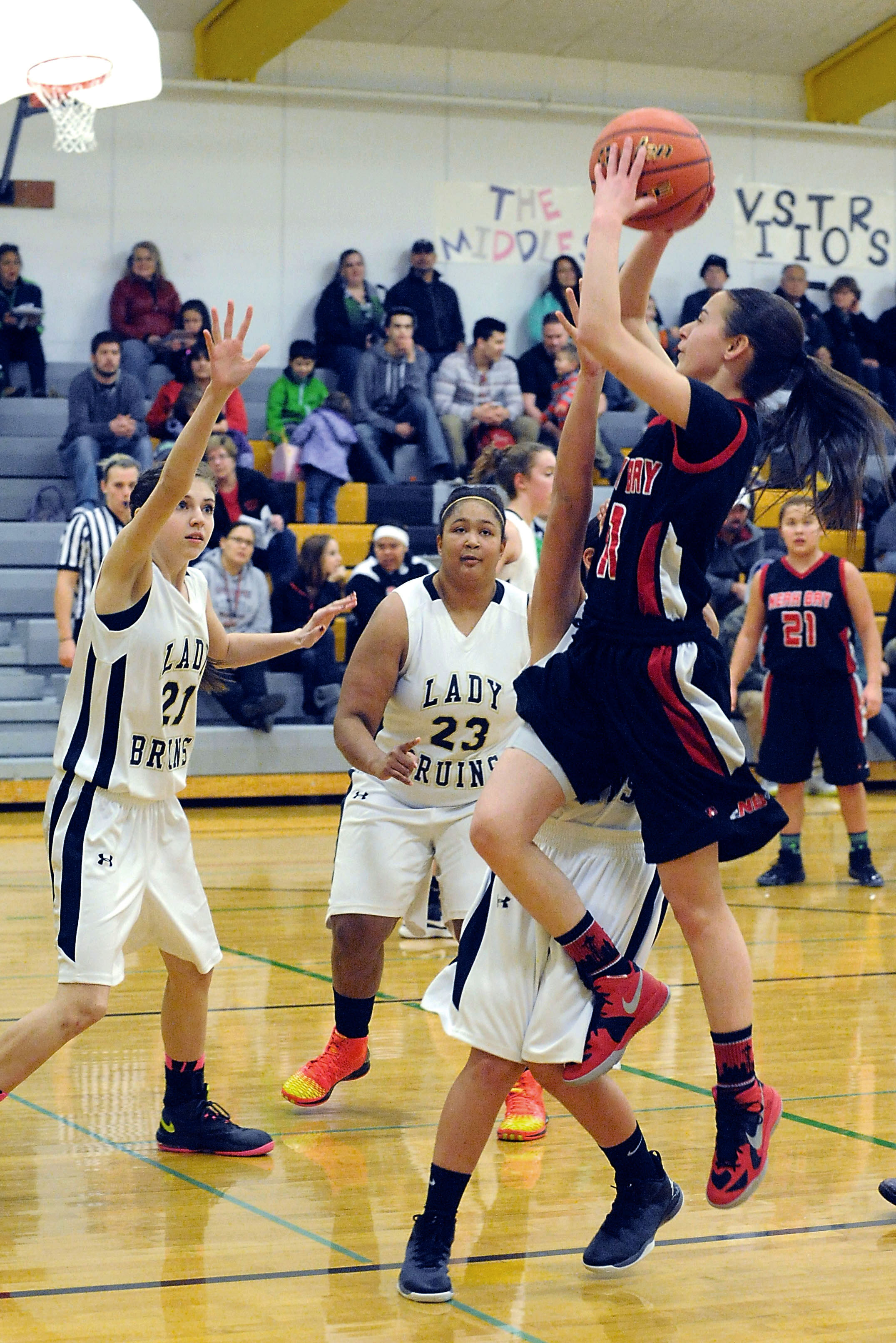 Neah Bay freshman Jessica Greene puts up a shot over Clallam Bay's Jennica Maines (21)