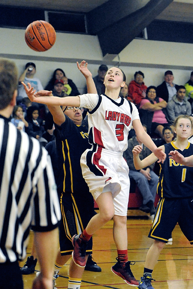 Neah Bay's Jessica Greene (3) puts up a shot around the defense of Forks' Vee Goodlance and Jordyn Henry (1). (Lonnie Archibald/for Peninsula Daily News)
