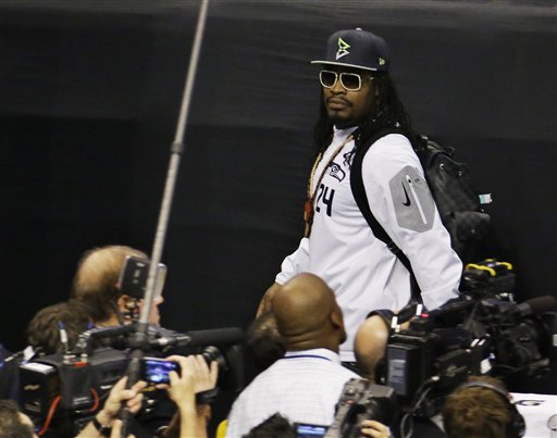 Seattle Seahawks' Marshawn Lynch leaves at the beginning of Media Day on Tuesday. (The Associated Press (Click on photo to enlarge))