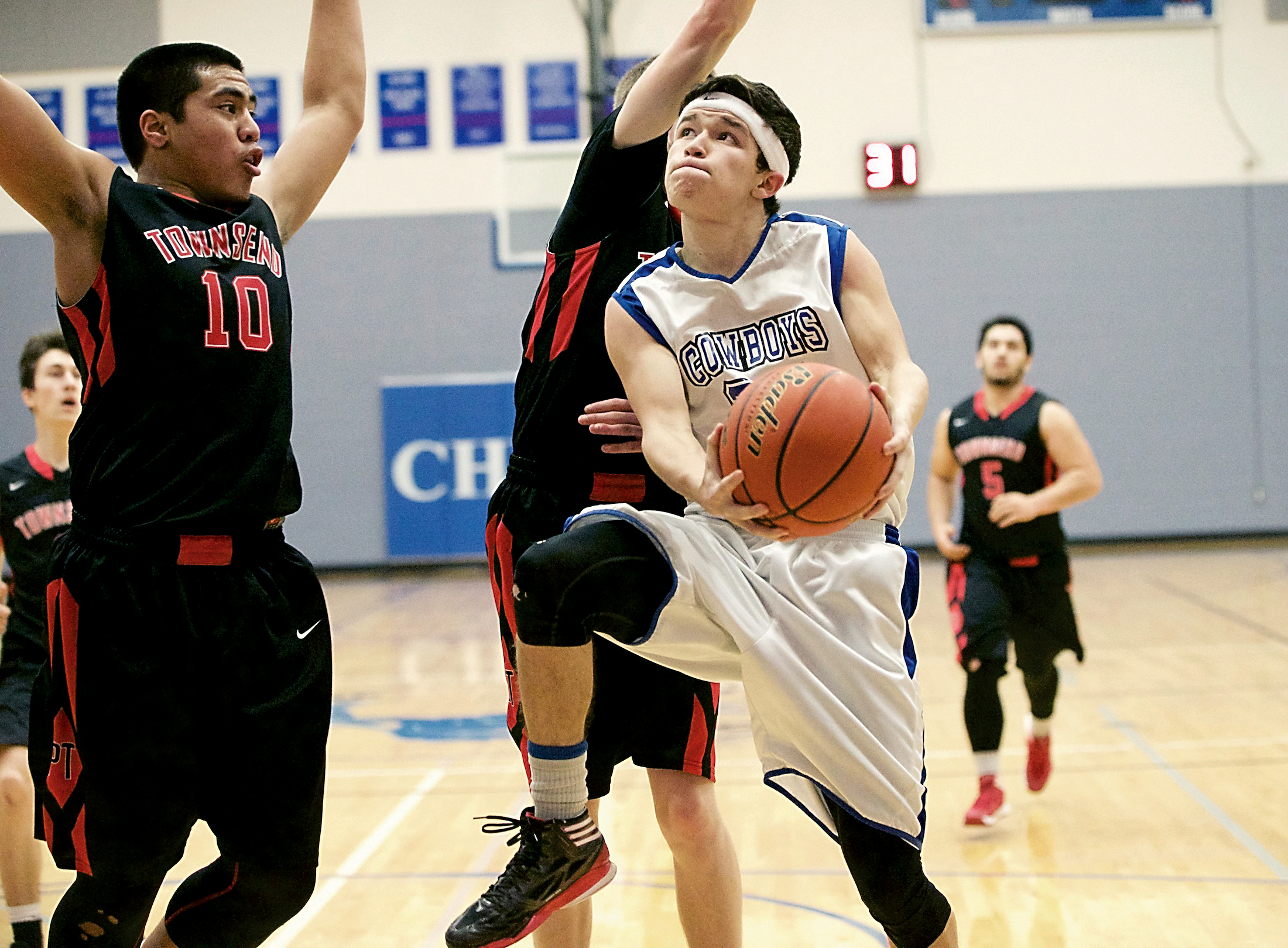 Chimacum's Mathew Torres shoots against Port Townsend's Detritus Kelsall