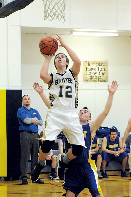 Clallam Bay's Ryan McCoy (12) scores in front of Crescent's Eli Williams. (Lonnie Archibald/for Peninsula Daily News)