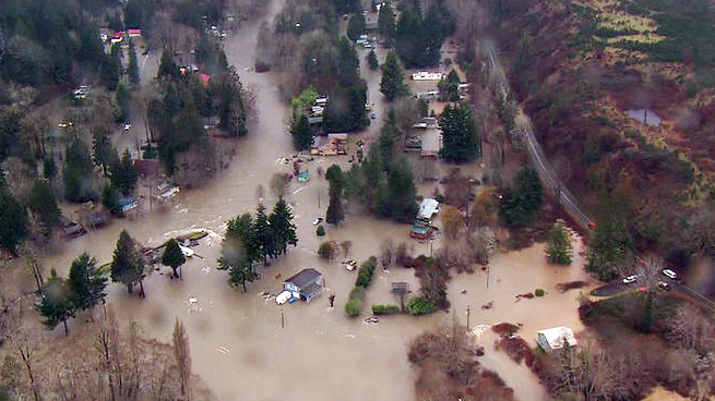 The Brinnon-area neighborhood over which the Duckabush River overflowed its banks Friday. (KOMO News)