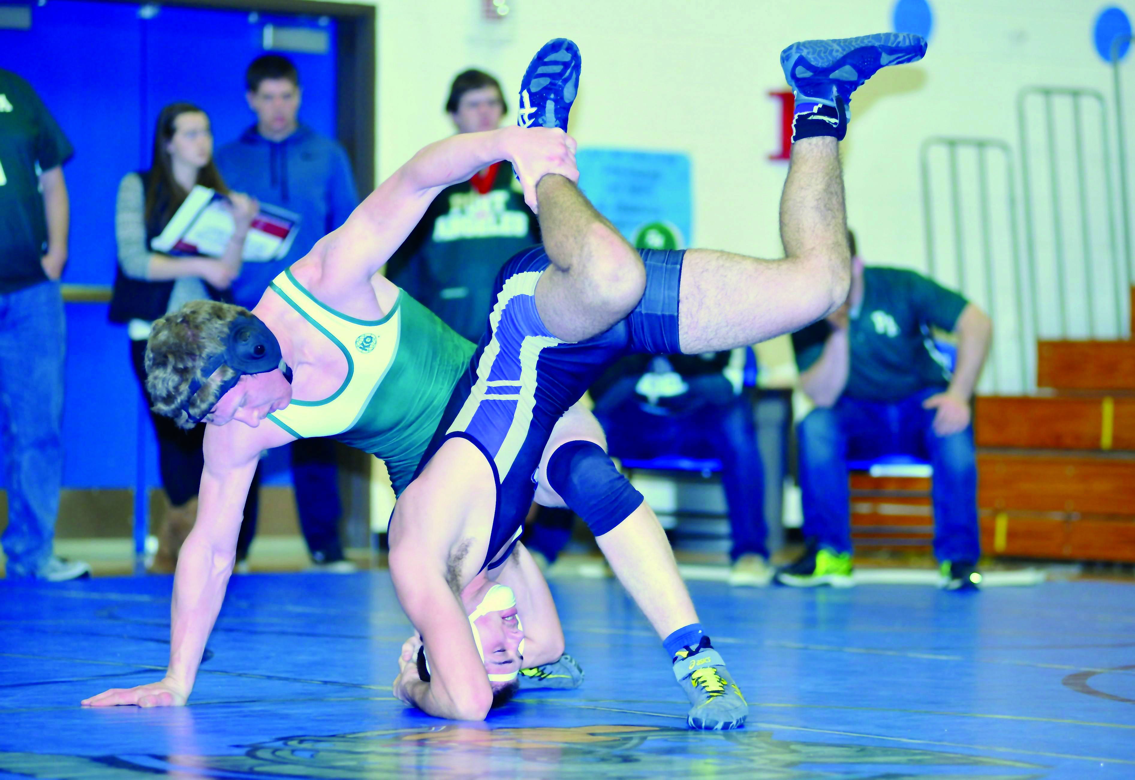Port Angeles' Evan Gallacci upends Sequim's Adrian Klarich during the 182-pound final at the Olympic League sub-regional meet. Gallacci won the title via a 14-5 major decision victory. (Jeff Halstead/for Peninsula Daily News)